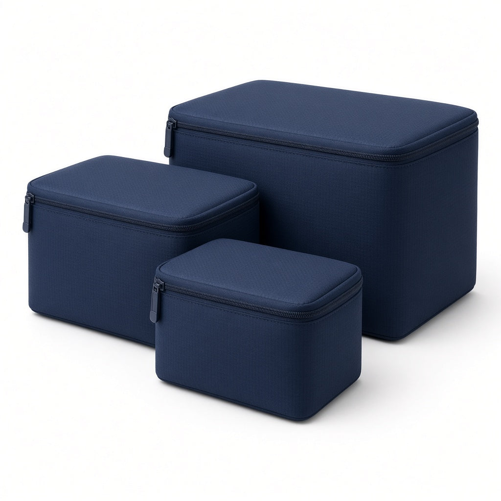 Three navy packing cubes on a white background